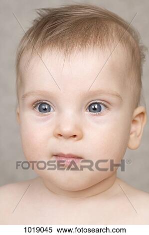 A baby boy staring blankly off camera View Large Photo Image Stock Photography - A baby boy staring blankly off camera. Fotosearch