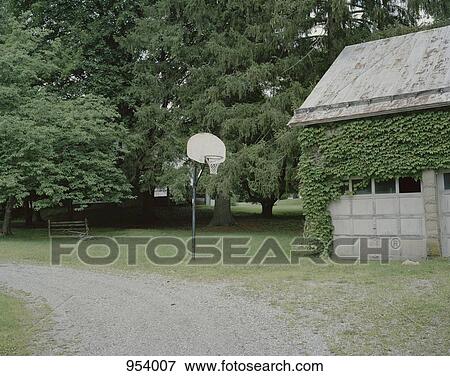 A basketball hoop next to a garage View Large Photo Image Stock Photo - A basketball hoop next to a garage. Fotosearch