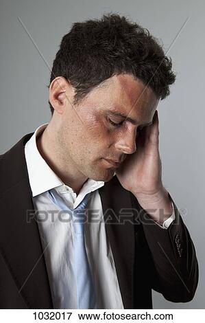 A beaten up businessman in pain View Large Photo Image Stock Photo - A beaten up businessman in pain. Fotosearch