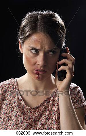 A beaten up woman using a cordless phone View Large Photo Image Stock Image - A beaten up woman using a cordless phone. Fotosearch