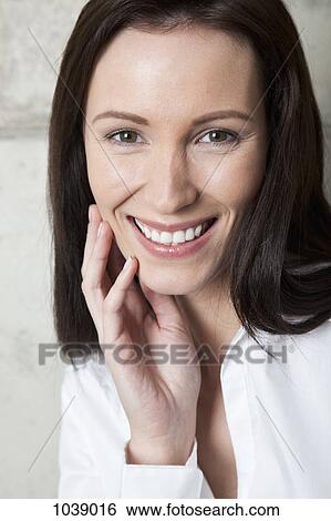 A beautiful woman smiling at the camera View Large Photo Image Stock Photograph - A beautiful woman smiling at the camera. Fotosearch