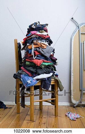 A big untidy stack of clean clothes waiting to be ironed View Large Photo Image Stock Photo - A big untidy stack of clean clothes waiting to be ironed. Fotosearch