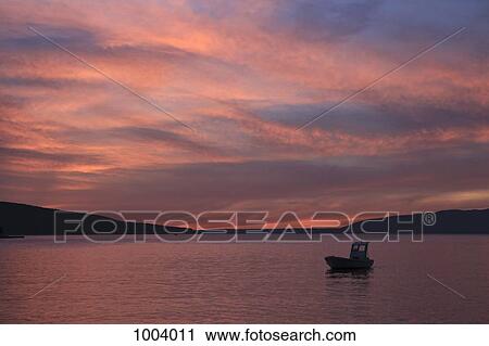 Stock Image - A boat moored near Cres on the Adriatic Sea, Croatia. Fotosearch