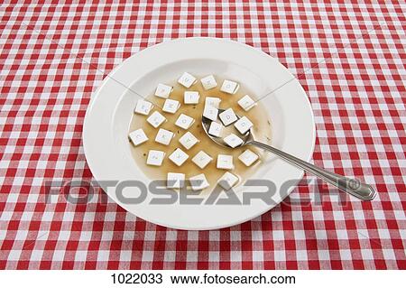 Stock Image - A bowl of soup with various computer keys floating in it. Fotosearch