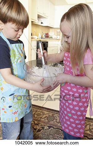 A boy and a girl mixing ingredients in a bowl View Large Photo Image Stock Photography - A boy and a girl mixing ingredients in a bowl. Fotosearch