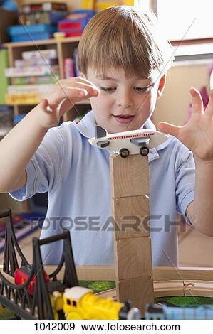 Stock Photo - A boy playing with toys. Fotosearch