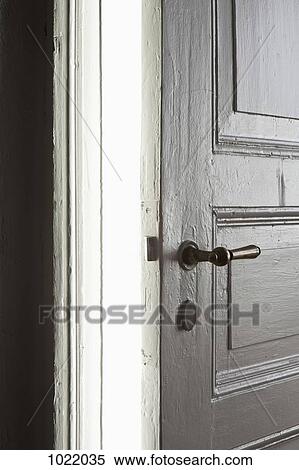 A bright light emitting from a door left ajar View Large Photo Image Stock Photography - A bright light emitting from a door left ajar. Fotosearch