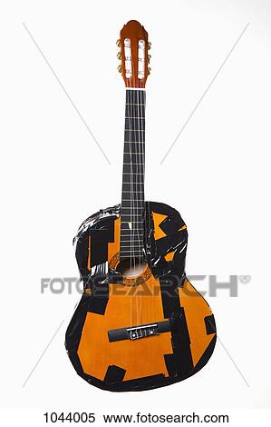 Stock Photography - A broken guitar taped together with duct tape. Fotosearch