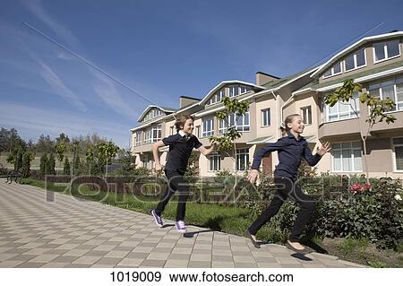 A brother chasing his sister, outdoors View Large Photo Image Stock Photo - A brother chasing his sister, outdoors. Fotosearch