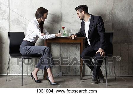 A businessman and businesswoman having a meeting in a modern office View Large Photo Image Picture - A businessman and businesswoman having a meeting in a modern office. Fotosearch