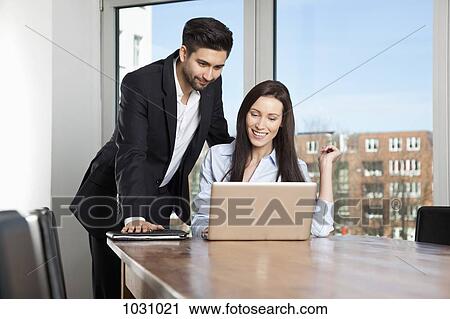 A businessman and businesswoman having a meeting in a board room View Large Photo Image Stock Image - A businessman and businesswoman having a meeting in a board room. Fotosearch