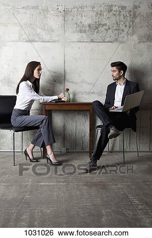 A businessman and businesswoman having a meeting in a modern office View Large Photo Image Stock Photograph - A businessman and businesswoman having a meeting in a modern office. Fotosearch