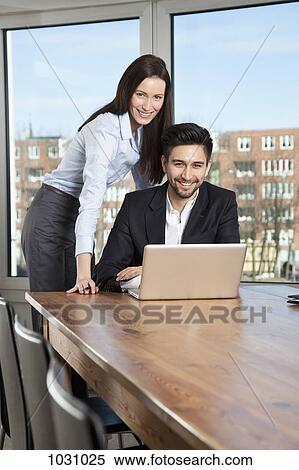 A businessman and businesswoman having a meeting in a board room View Large Photo Image Stock Photography - A businessman and businesswoman having a meeting in a board room. Fotosearch