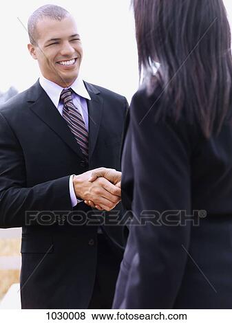 A businessman and businesswoman shaking hands View Large Photo Image Stock Photo - A businessman and businesswoman shaking hands. Fotosearch
