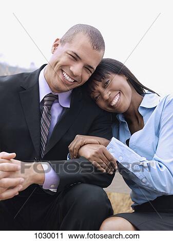 A businessman and businesswoman relaxing together, outdoors View Large Photo Image Stock Image - A businessman and businesswoman relaxing together, outdoors. Fotosearch