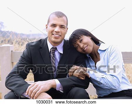 A businessman and businesswoman relaxing together, outdoors View Large Photo Image Stock Image - A businessman and businesswoman relaxing together, outdoors. Fotosearch