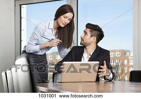 A businessman and businesswoman strategizing View Large Photo Image Stock Image - A businessman and businesswoman strategizing. Fotosearch