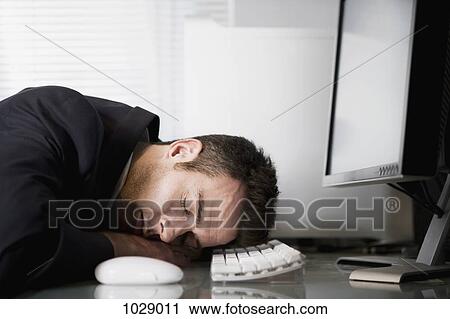 A businessman asleep at his desk View Large Photo Image Stock Image - A businessman asleep at his desk. Fotosearch