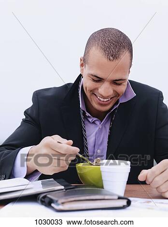A businessman having breakfast, outdoors View Large Photo Image Stock Image - A businessman having breakfast, outdoors. Fotosearch