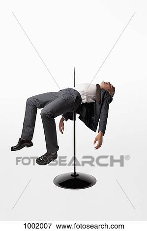 Stock Photo - A businessman impaled on a spindle. Fotosearch