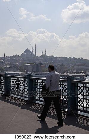 A businessman walking across the Galata Bridge, Istanbul, Turkey View Large Photo Image Stock Image - A businessman walking across the Galata Bridge, Istanbul, Turkey. Fotosearch