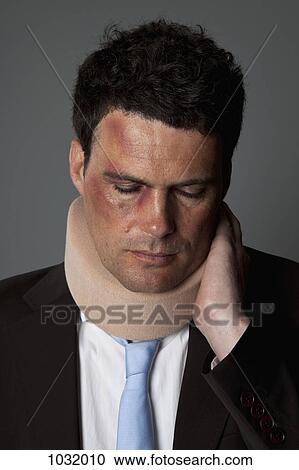 Stock Image - A businessman wearing a neck brace. Fotosearch