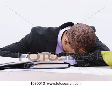 A businessman with his head down on a table, outdoors View Large Photo Image Stock Image - A businessman with his head down on a table, outdoors. Fotosearch