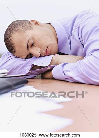 A businessman with his head resting on his arm, eyes closed, outdoors View Large Photo Image Stock Photography - A businessman with his head resting on his arm, eyes closed, outdoors. Fotosearch