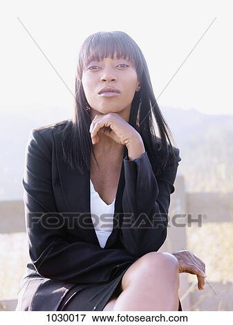 A businesswoman sitting outdoors, portrait View Large Photo Image Stock Photo - A businesswoman sitting outdoors, portrait. Fotosearch