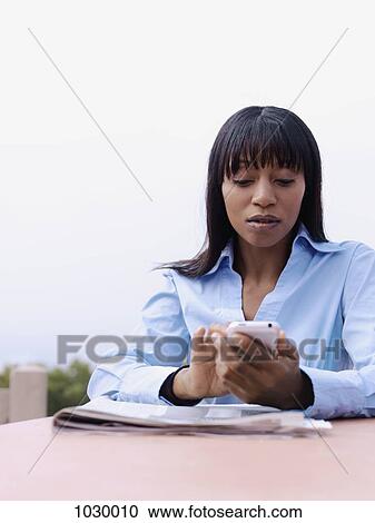 A businesswoman text messaging View Large Photo Image Stock Image - A businesswoman text messaging. Fotosearch
