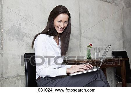 A businesswoman typing on a laptop View Large Photo Image Picture - A businesswoman typing on a laptop. Fotosearch