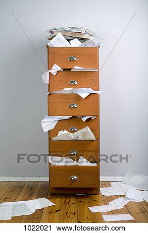 A cabinet stuffed with overflowing papers View Large Photo Image Stock Image - A cabinet stuffed with overflowing papers. Fotosearch