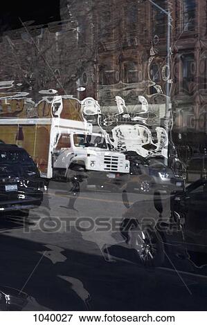 A city street scene distorted in the reflection of a tinted window View Large Photo Image Stock Photo - A city street scene distorted in the reflection of a tinted window. Fotosearch