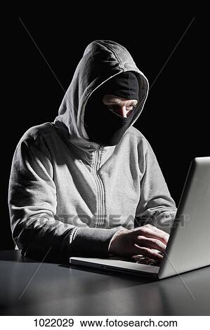 Stock Photo - A computer hacker. Fotosearch