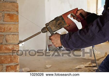 A construction worker using a jackhammer drill View Large Photo Image Stock Photograph - A construction worker using a jackhammer drill. Fotosearch