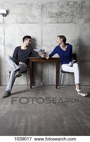 A couple enjoying themselves at cafe View Large Photo Image Stock Photo - A couple enjoying themselves at cafe. Fotosearch