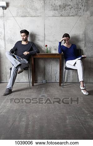 A couple ignoring each other while reading separate magazines View Large Photo Image Stock Photograph - A couple ignoring each other while reading separate magazines. Fotosearch
