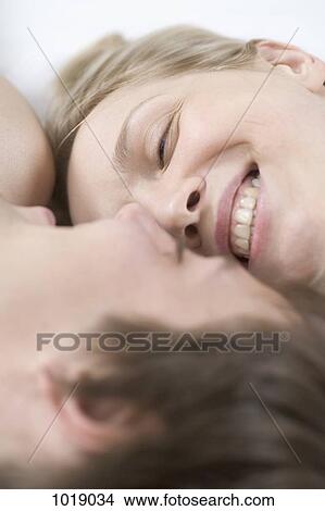 A couple laughing together, close-up View Large Photo Image Picture - A couple laughing together, close-up. Fotosearch