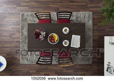 A dining table with coffee cups and newspaper, overhead view View Large Photo Image Stock Photograph - A dining table with coffee cups and newspaper, overhead view. Fotosearch