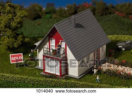 A diorama of a miniature house with a family of figurines and a SOLD sign View Large Photo Image Stock Image - A diorama of a miniature house with a family of figurines and a SOLD sign. Fotosearch
