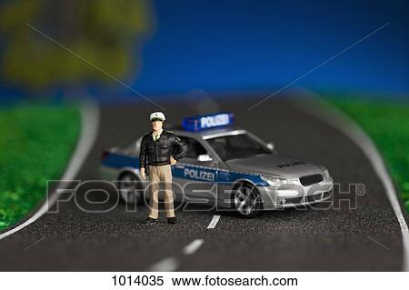 A diorama of a miniature policeman figurine standing by a miniature police car View Large Photo Image Stock Photography - A diorama of a miniature policeman figurine standing by a miniature police car. Fotosearch