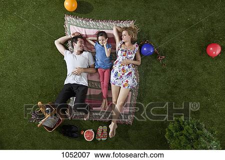 Stock Photo - A family having a picnic in the park, overhead view. Fotosearch