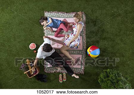 Stock Photo - A family having a picnic in the park, overhead view. Fotosearch
