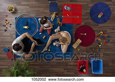 A family playing together in their living room, overhead view View Large Photo Image Stock Image - A family playing together in their living room, overhead view. Fotosearch