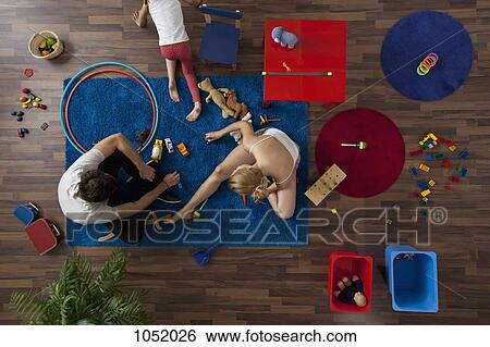 A family playing with toys in their living room, overhead view View Large Photo Image Stock Photograph - A family playing with toys in their living room, overhead view. Fotosearch