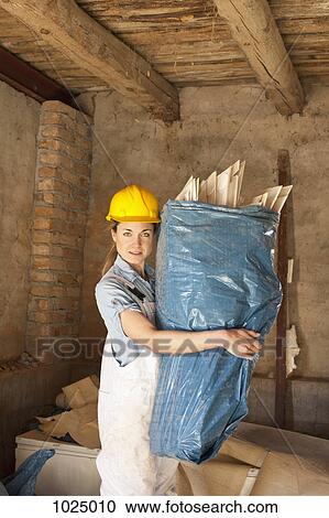 A female construction worker carrying trash View Large Photo Image Stock Image - A female construction worker carrying trash. Fotosearch