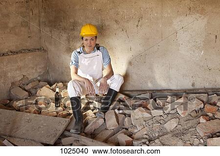 A female construction worker sitting on rubble with a beer View Large Photo Image Stock Image - A female construction worker sitting on rubble with a beer. Fotosearch