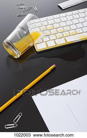 A glass of orange juice spilled on a computer keyboard View Large Photo Image Stock Image - A glass of orange juice spilled on a computer keyboard. Fotosearch