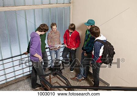 A group of teenagers hanging out in a school stairwell View Large Photo Image Stock Image - A group of teenagers hanging out in a school stairwell. Fotosearch