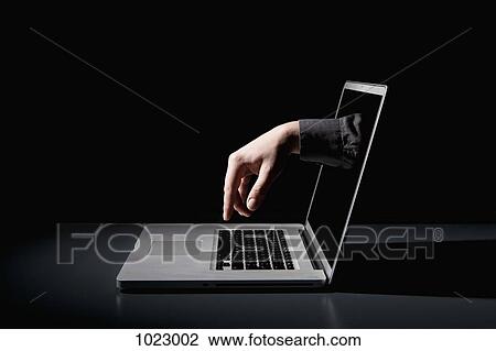A hand reaching through a laptop to type on the keyboard View Large Photo Image Stock Image - A hand reaching through a laptop to type on the keyboard. Fotosearch